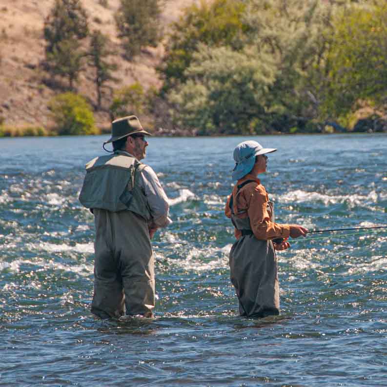 two flyfishers standing in stream fishing